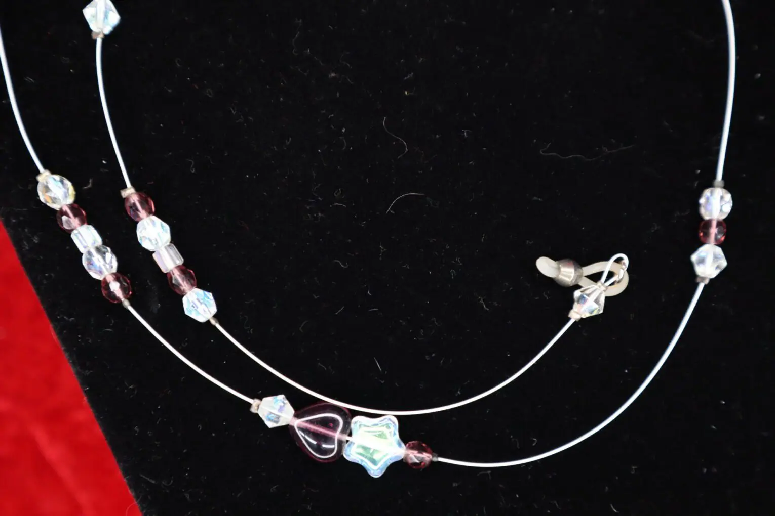 Colorful beaded necklace with unique charm shapes.
