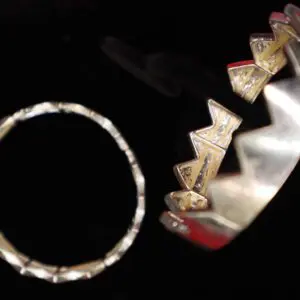 Silver and gold bracelets with unique designs.