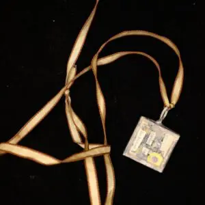 Vintage pendant necklace with floral design charm.