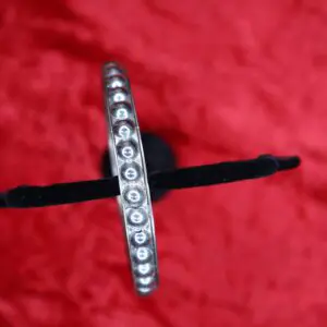 Silver bracelet with round decorative accents.