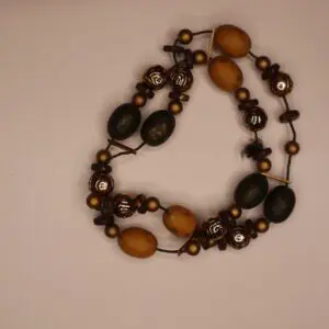 Beaded necklace featuring dark and golden elements.