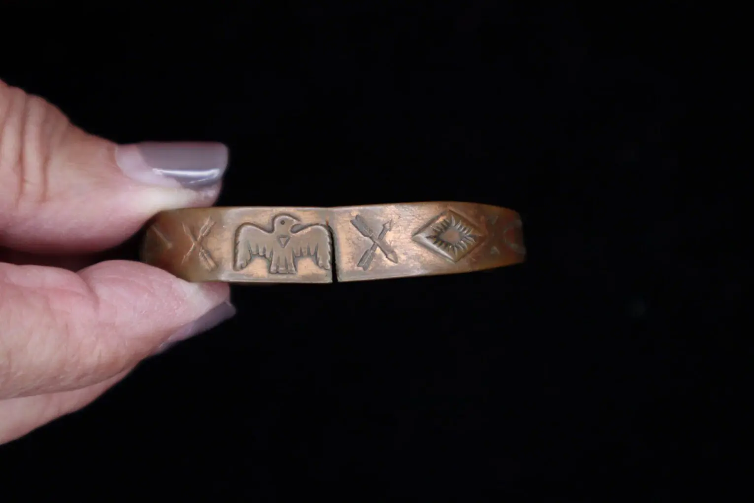 Bronze bracelet with engraved eagle design.