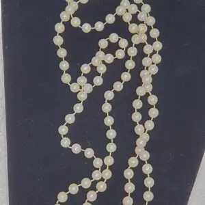 Elegant necklace made of light-colored beads.