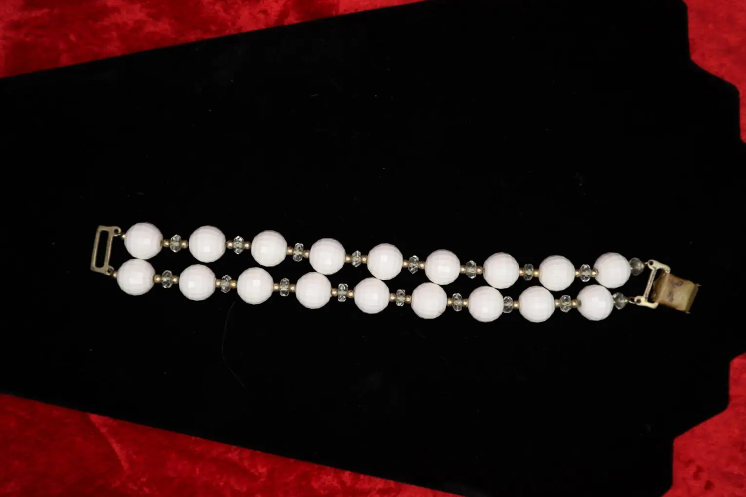 Elegant white beaded bracelet with metallic accents.