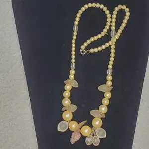 Yellow bead necklace with decorative accents.