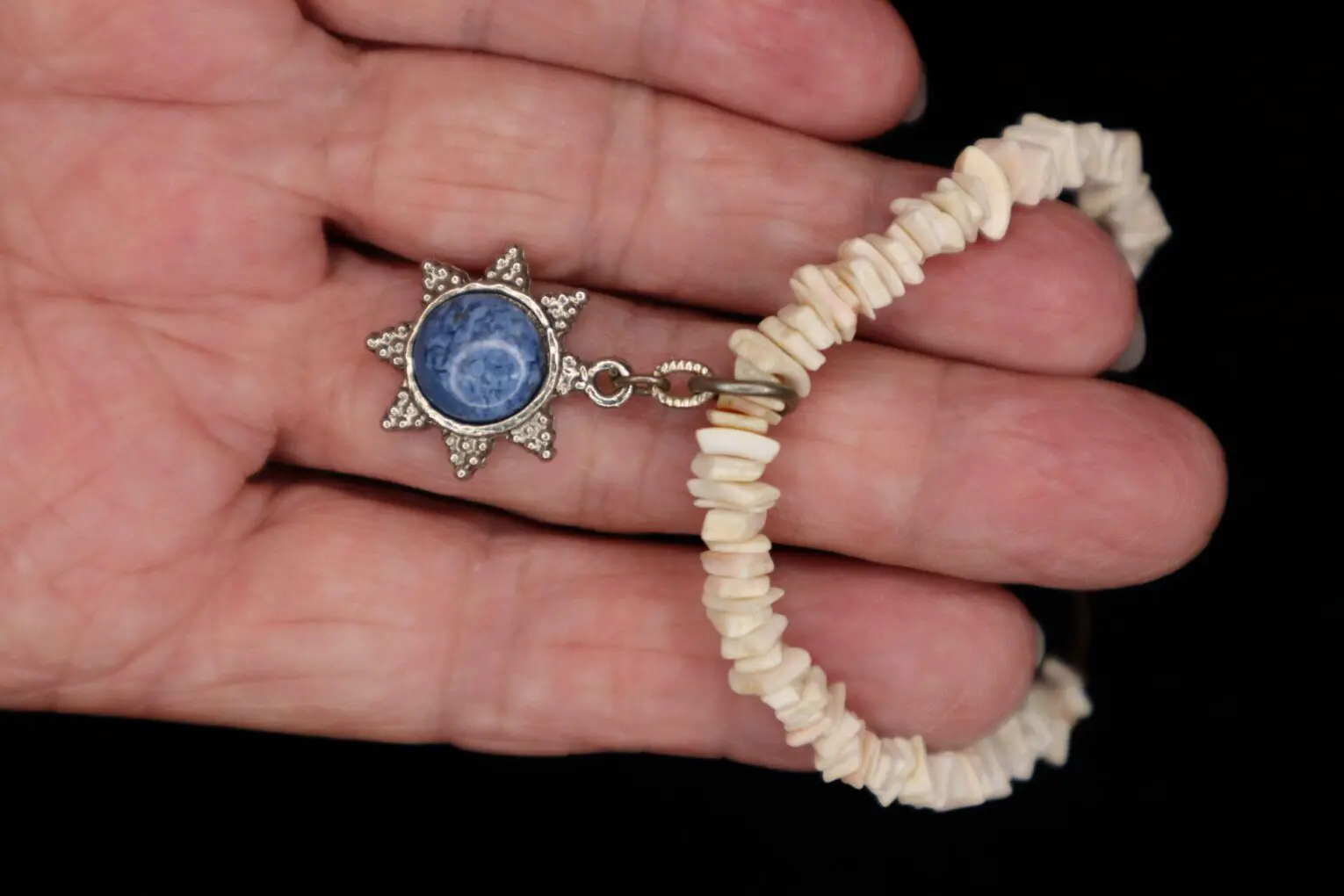 Beaded bracelet with star-shaped charm displayed.