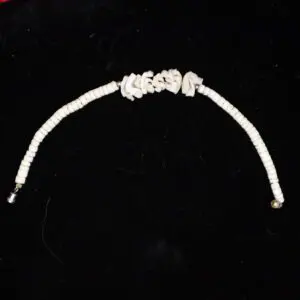 White beaded necklace with unique twisted design.