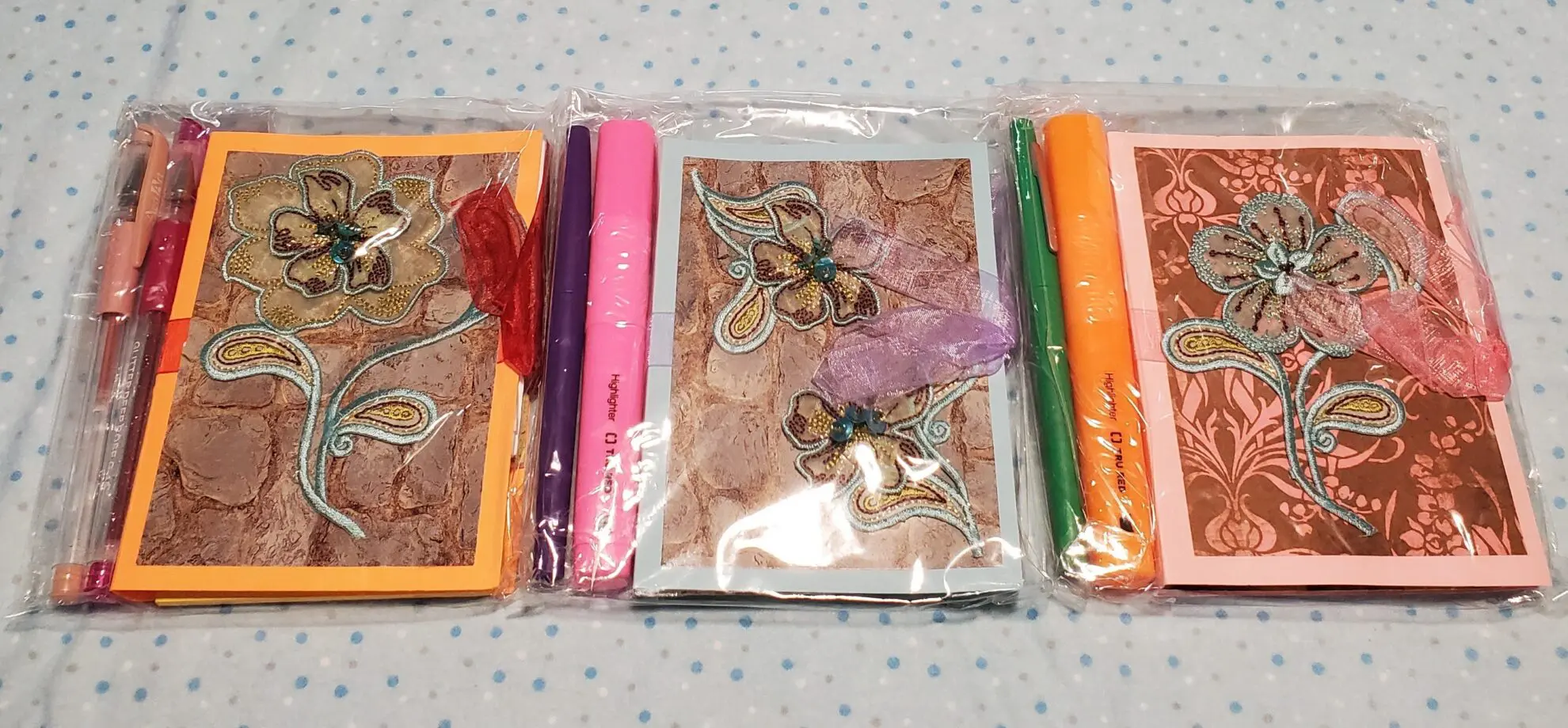 Colorful notepads with decorative pens included.
