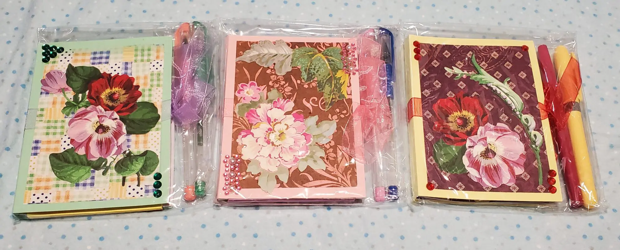 Floral notepads with decorative writing tools.
