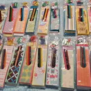 Colorful stationery sets with pens in packaging.