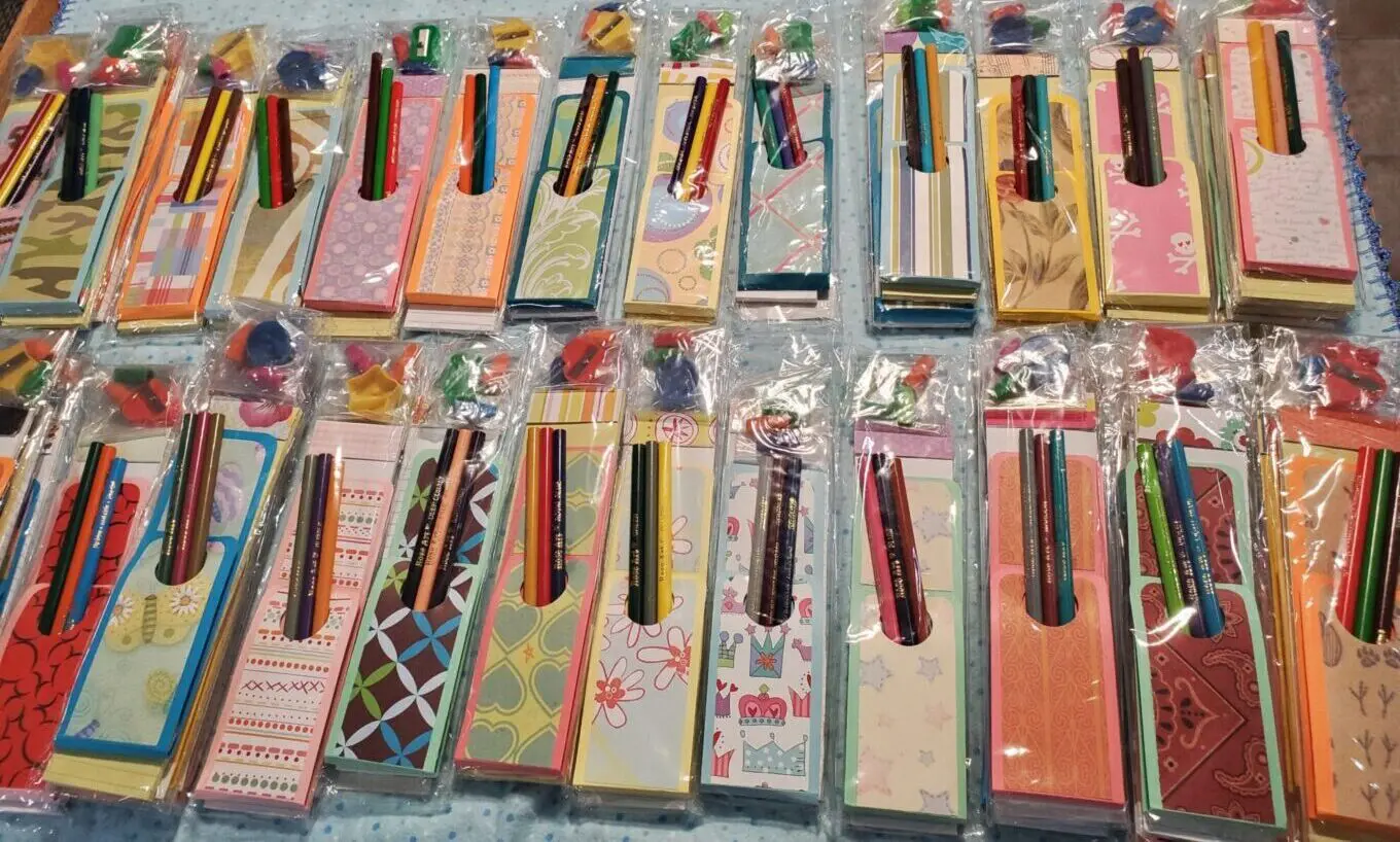 Colorful stationery sets with pens in packaging.