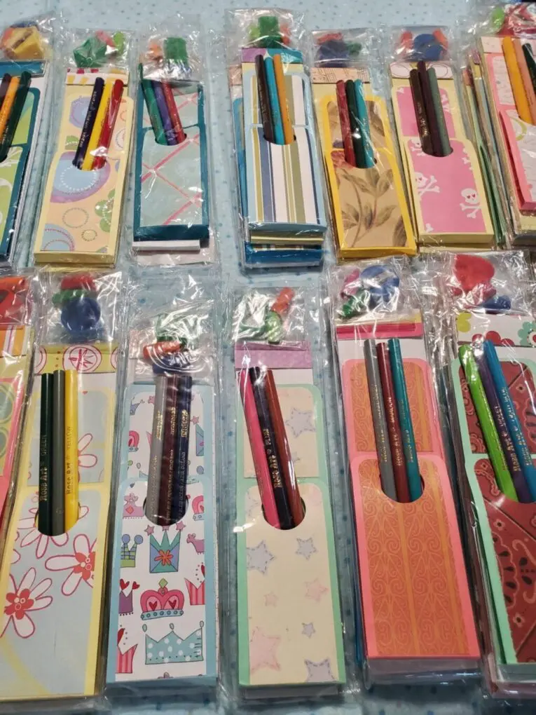 Colorful notepad sets with decorative pencils included.