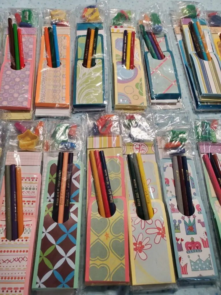 Colorful notepads and pencils in packaging.