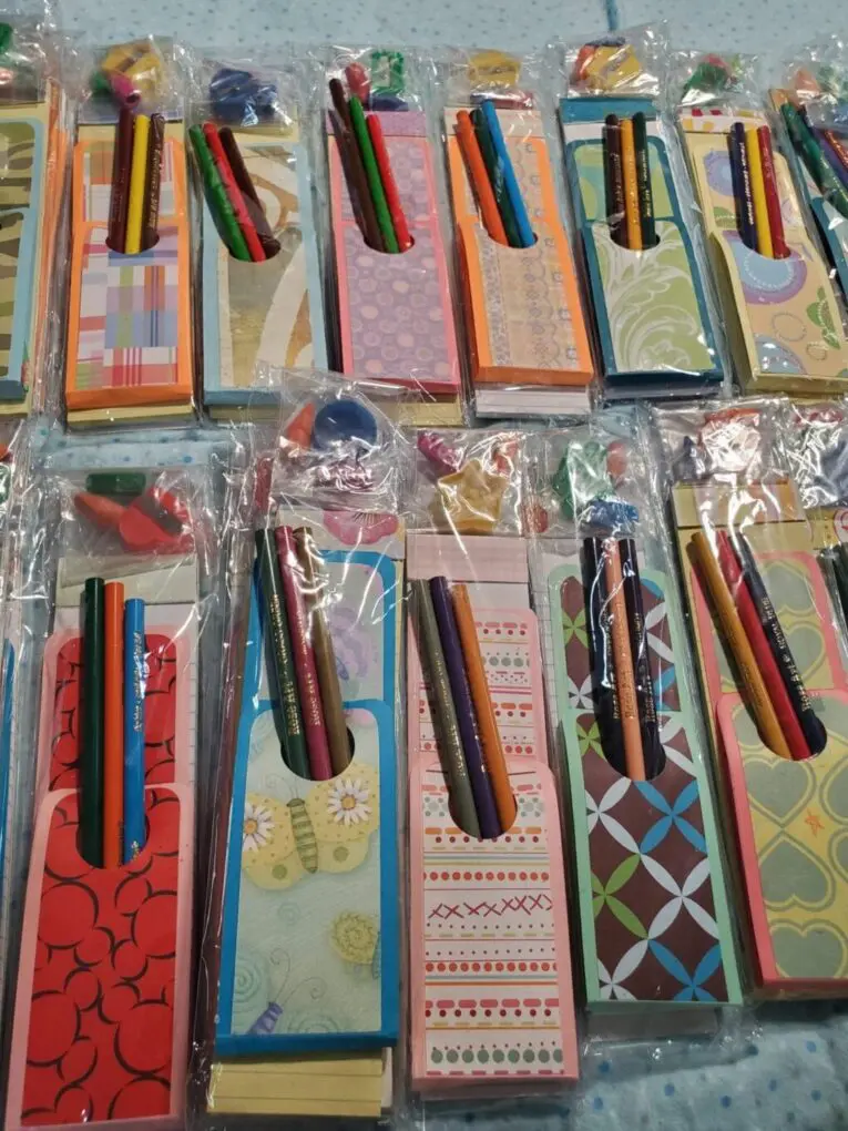 Colorful notepad sets with decorative pencils.