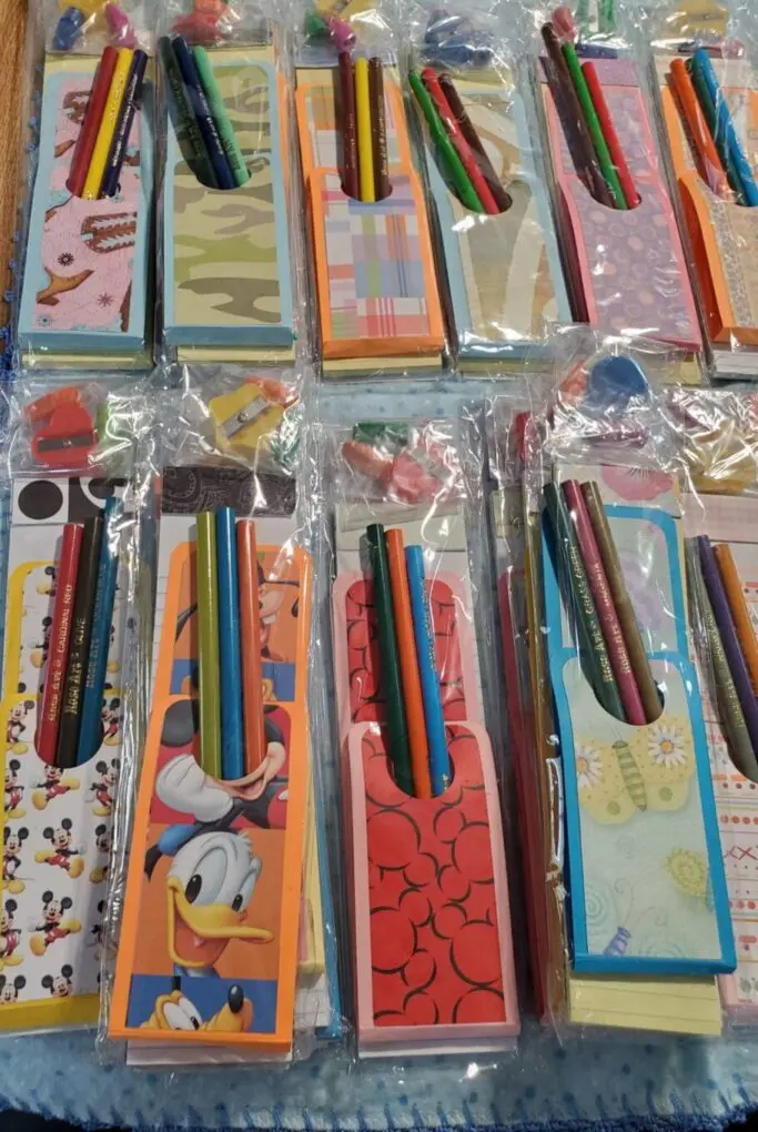 Colorful notepads with pencils in clear packaging.