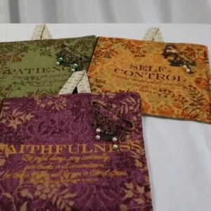 Three colorful fabric pouches with floral designs and text.