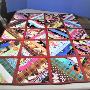 Colorful patchwork quilt with various geometric patterns on a table.