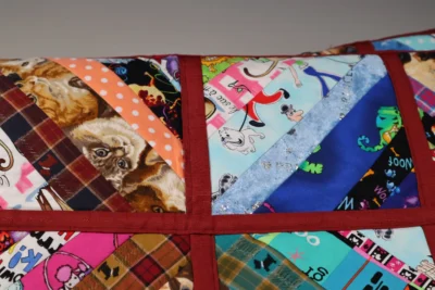 Four colorful quilt squares with various animal and pattern designs.