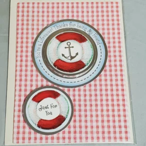 Nautical-themed greeting card with anchor and lifebuoy designs.