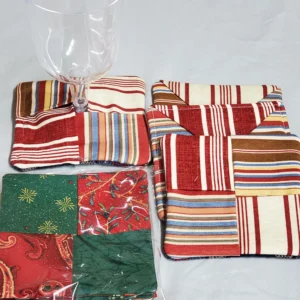 Two colorful patchwork pot holders with striped and floral patterns.