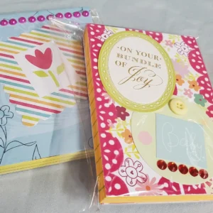Colorful handmade greeting cards with floral and heart designs.