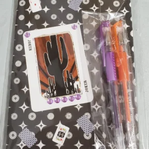 Colorful pens and a cactus sticker on a patterned surface.