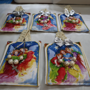 Colorful handmade fabric pouches with decorative ribbons and small ornaments.